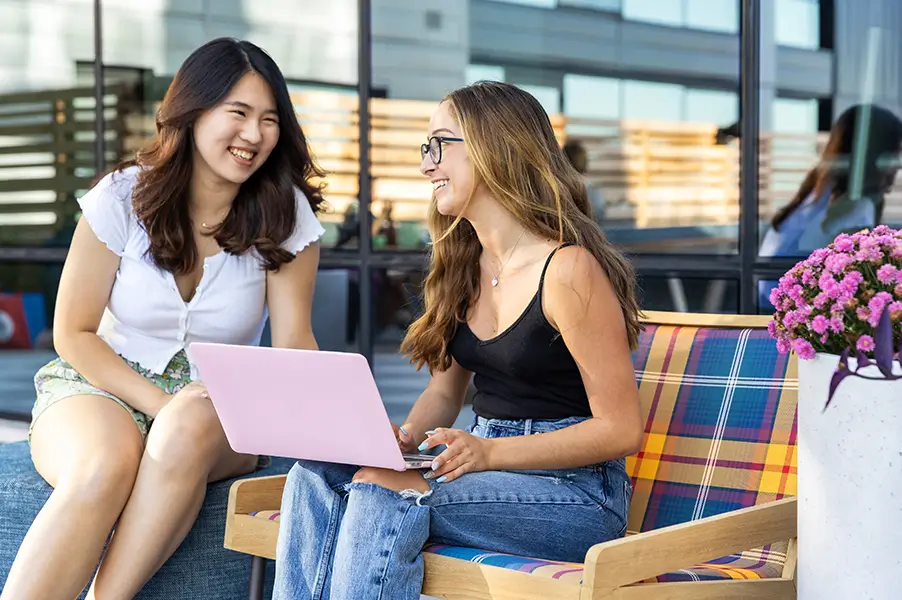 friends studying together on a laptop