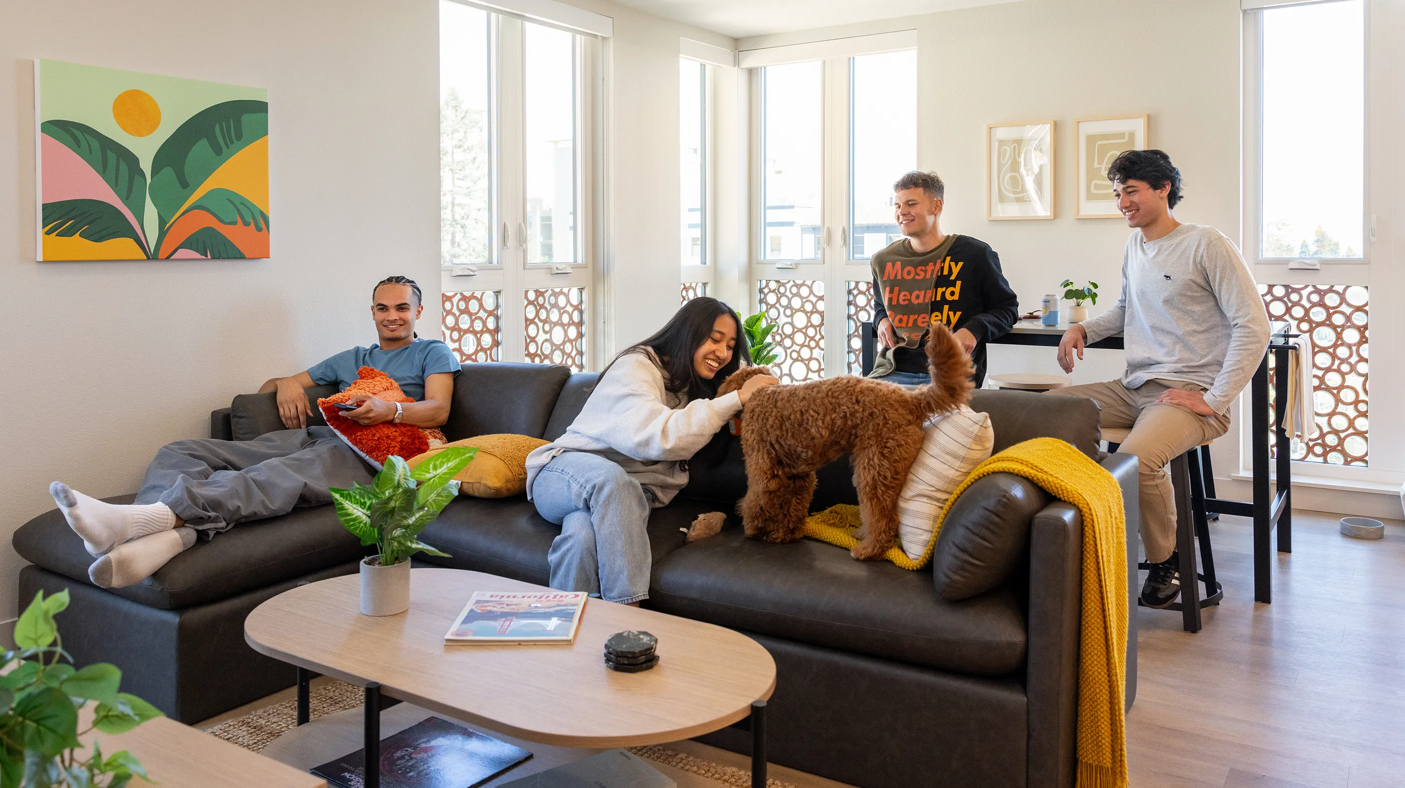 friends petting a dog in a living room