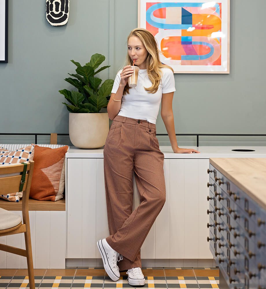 a woman drinking an iced coffee