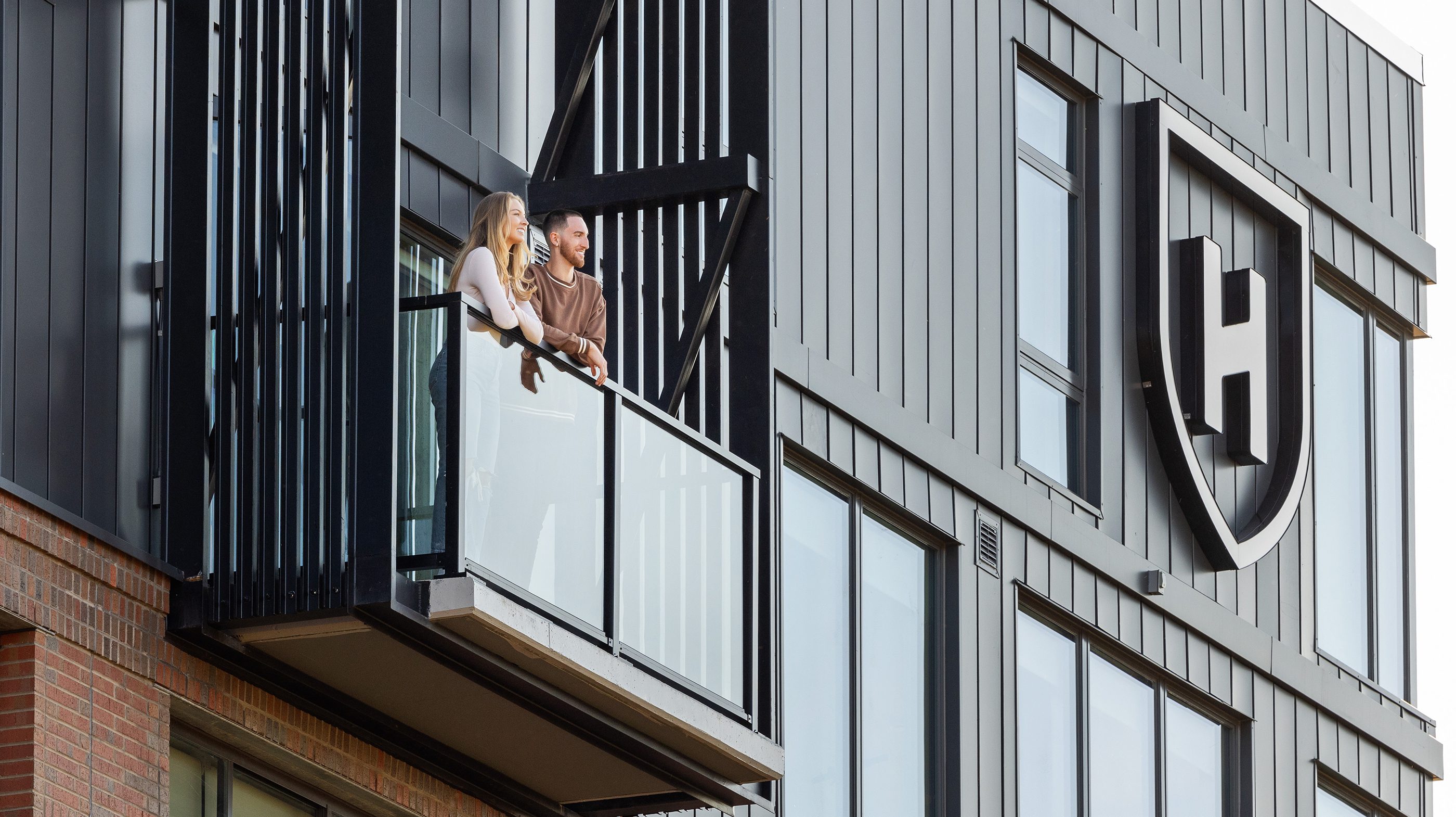 people looking over a balcony