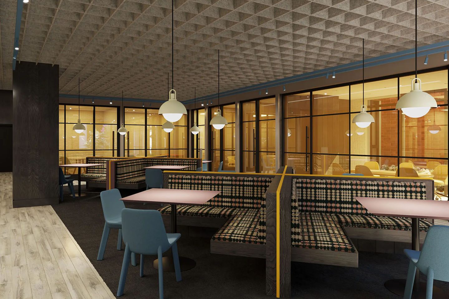 Large study room with ambient lighting, booths, chairs, and tables.